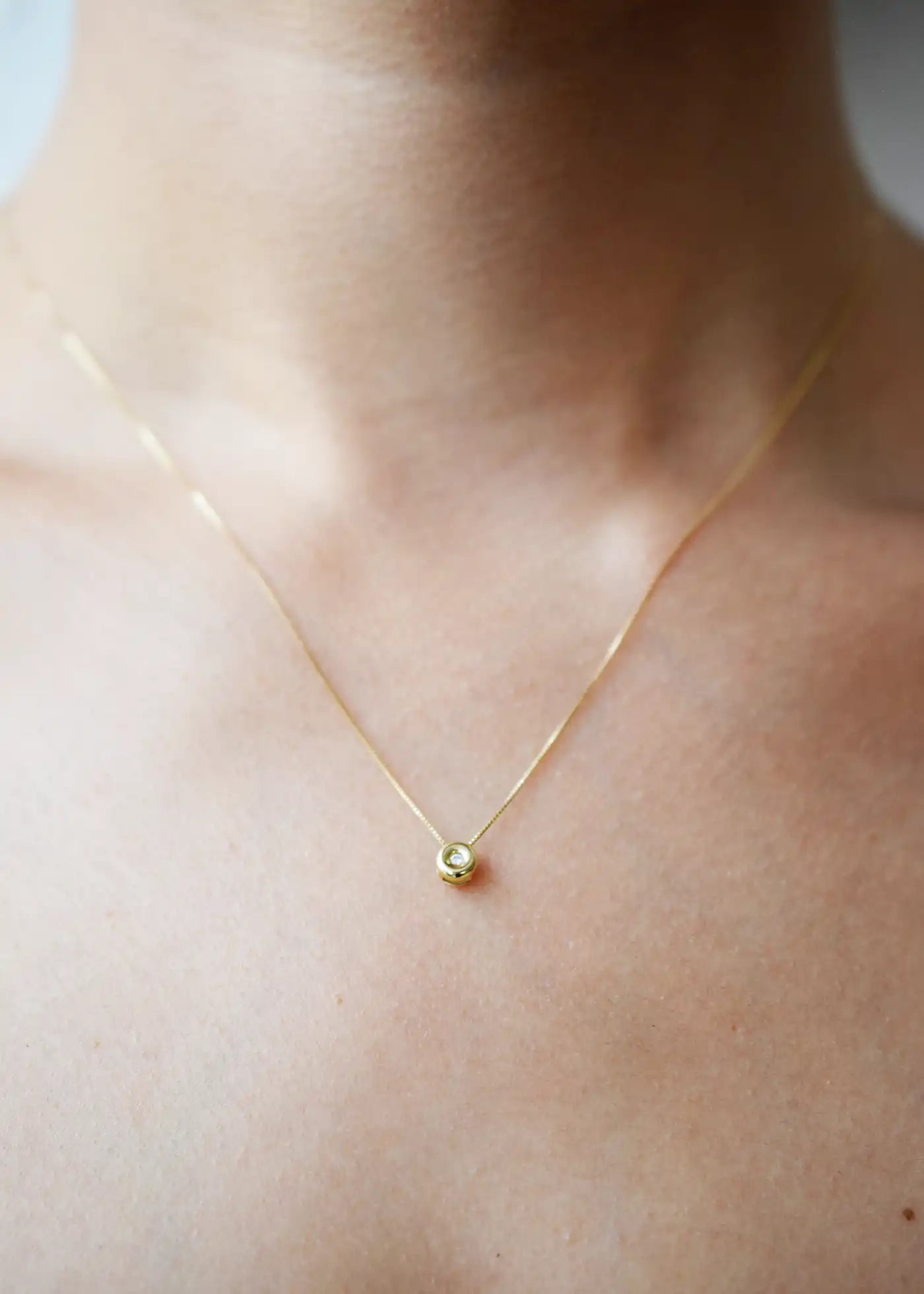 Delicate 18 Karat Yellow Gold Chain with a single, sparkling Brilliant-Cut Diamond Pendant.