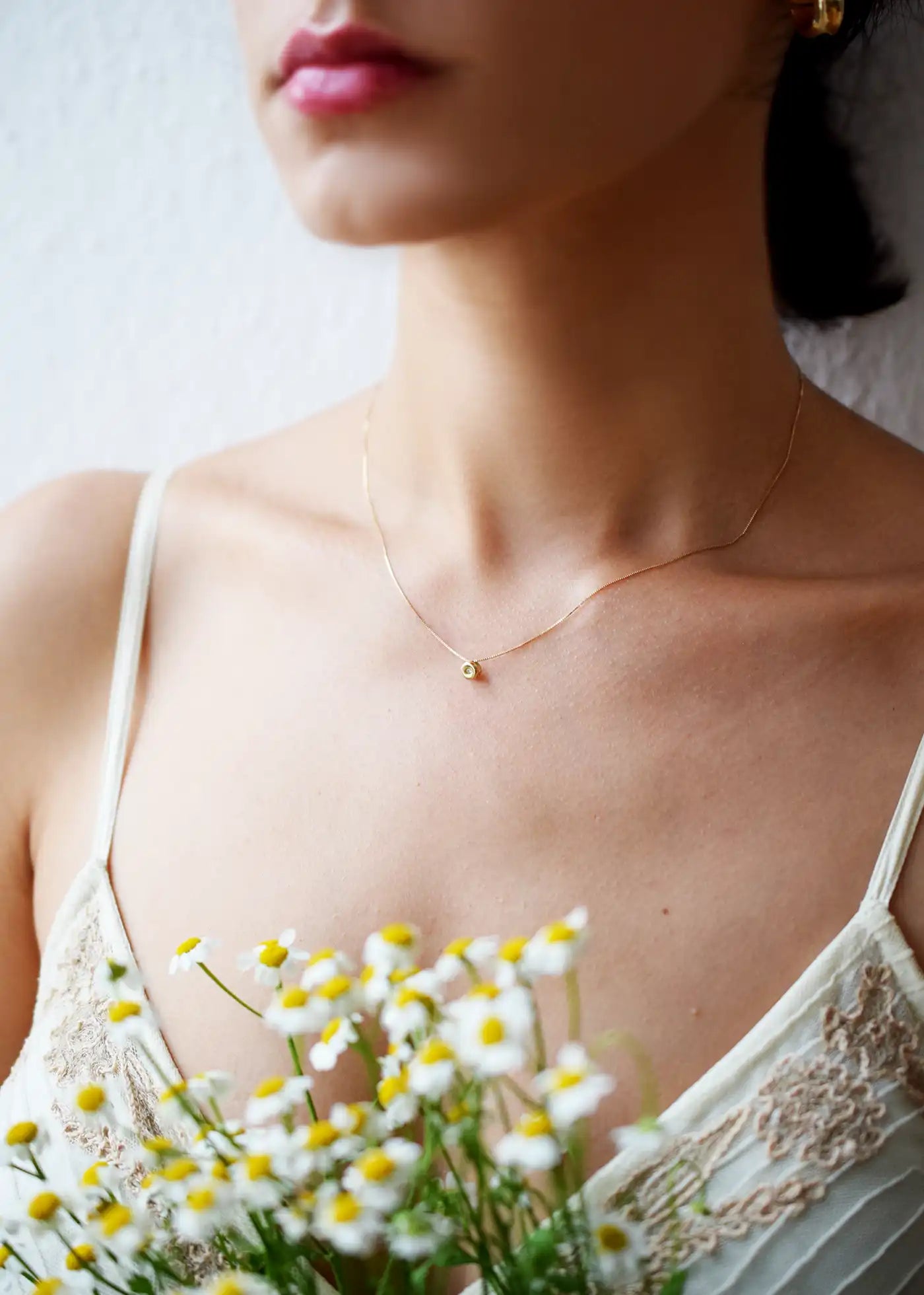 Delicate 18 Karat Yellow Gold Chain with a single, sparkling Brilliant-Cut Diamond Pendant.