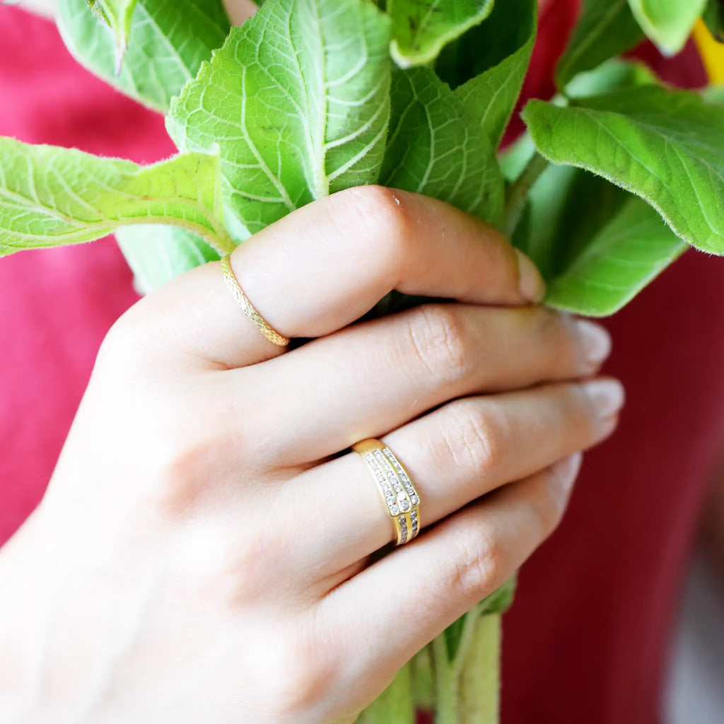 Elegant 18 Karat Yellow Gold band ring featuring multiple rows of brilliant-cut diamonds in a fine pavé setting.