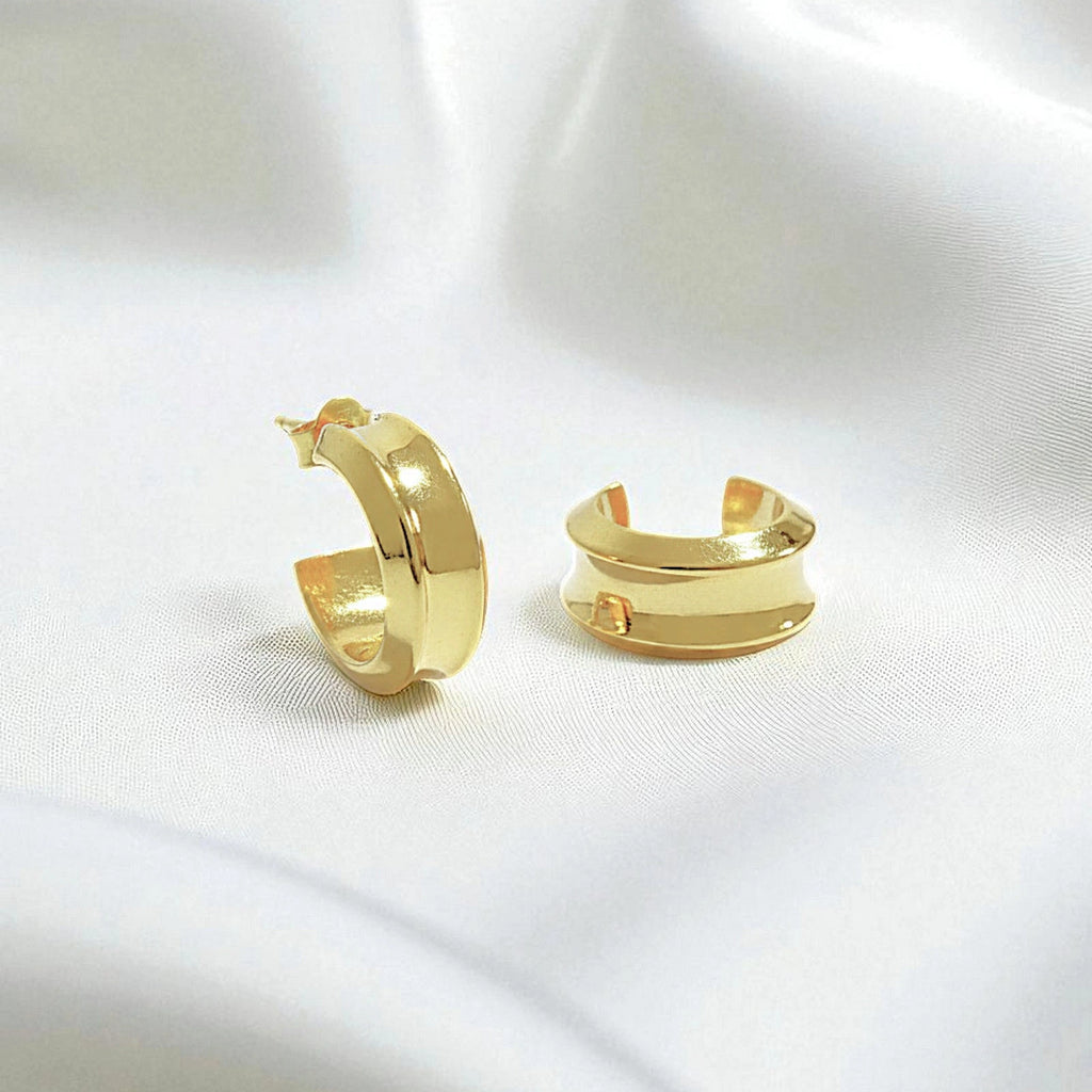 14 Karat Gold hoop earrings on a white silk background.