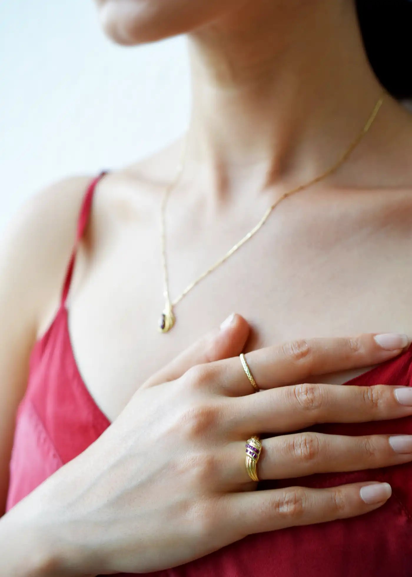 Elegant 18 Karat Yellow Gold Ring in a crossover design with channel-set baguette rubies and pavé-set diamonds.