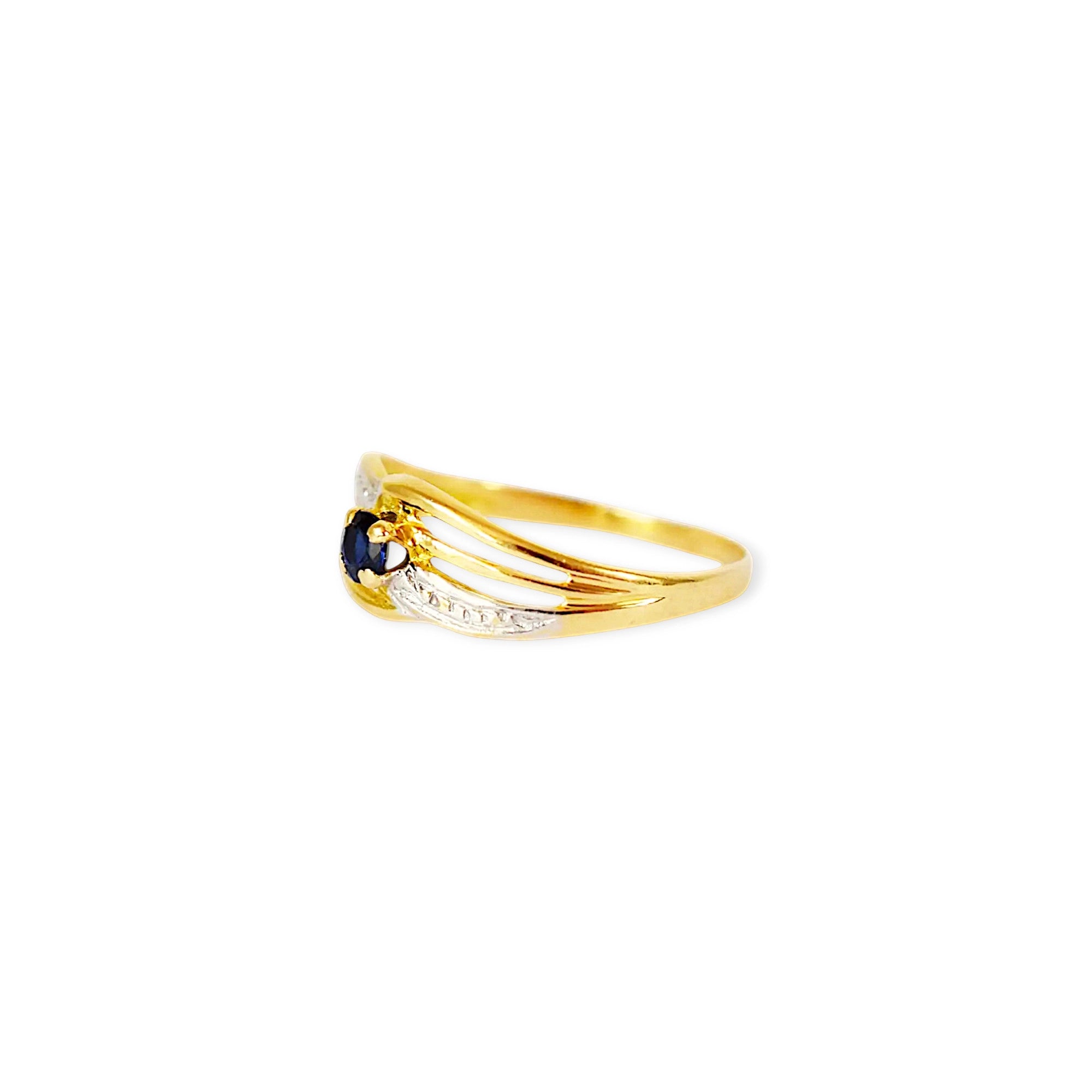 Elegant 18 Karat Yellow Gold ring featuring an oval blue sapphire.