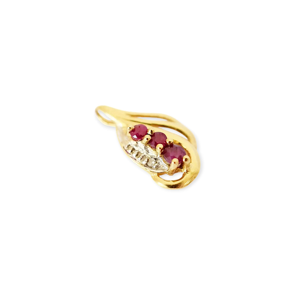 Elegant 18 Karat Yellow Gold vintage-style pendant with a sculpted, flowing design, featuring three vibrant rubies and a sparkling diamond accent.