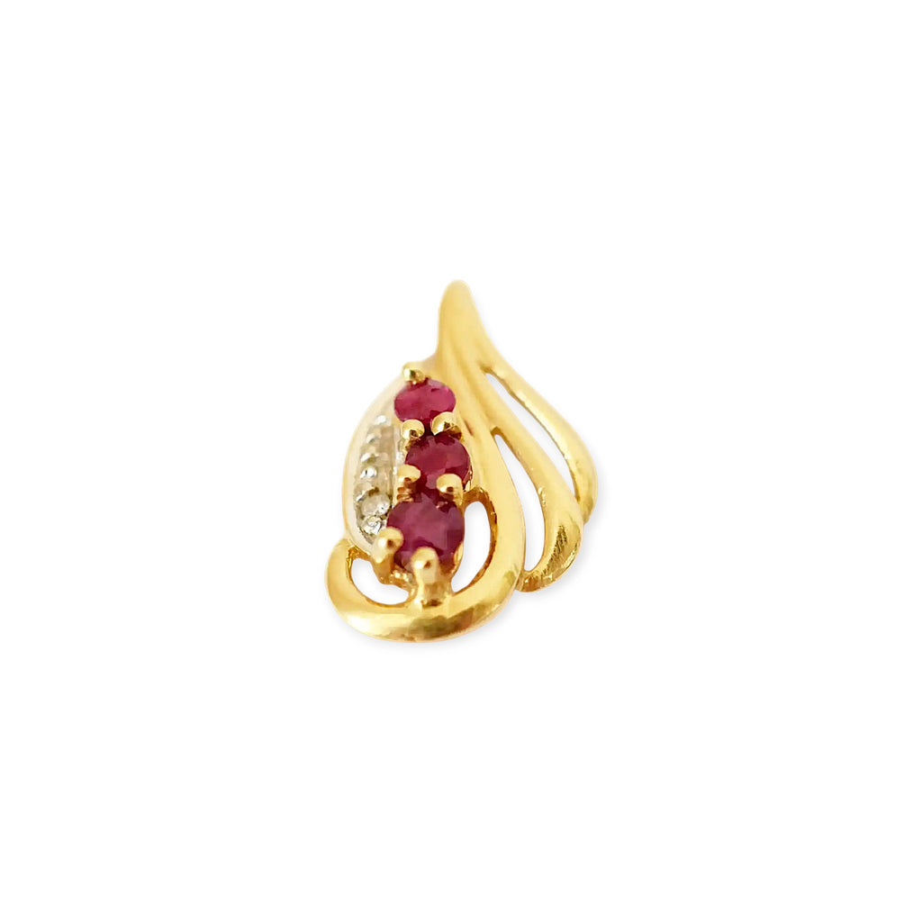 Elegant 18 Karat Yellow Gold vintage-style pendant with a sculpted, flowing design, featuring three vibrant rubies and a sparkling diamond accent.