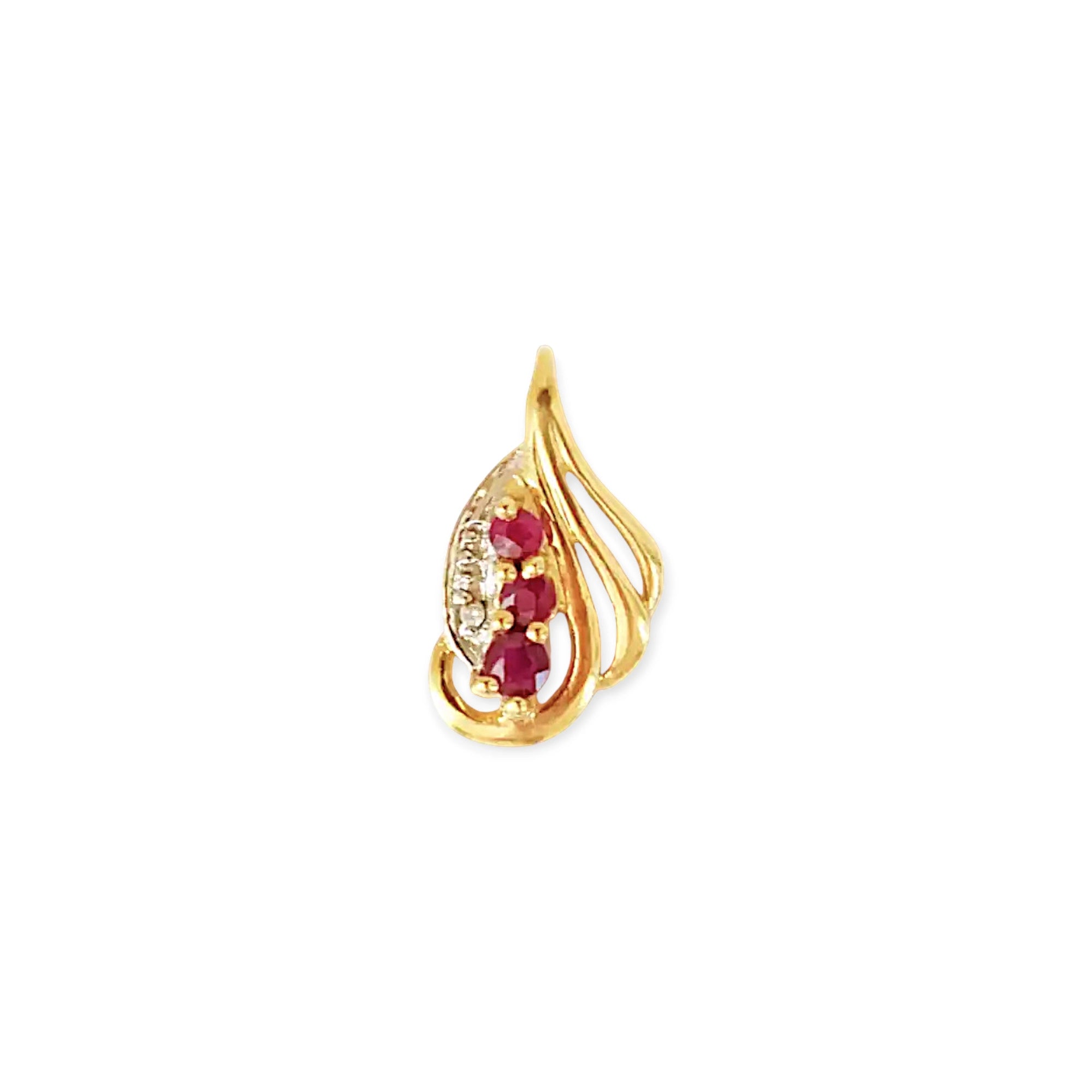Elegant 18 Karat Yellow Gold vintage-style pendant with a sculpted, flowing design, featuring three vibrant rubies and a sparkling diamond accent.
