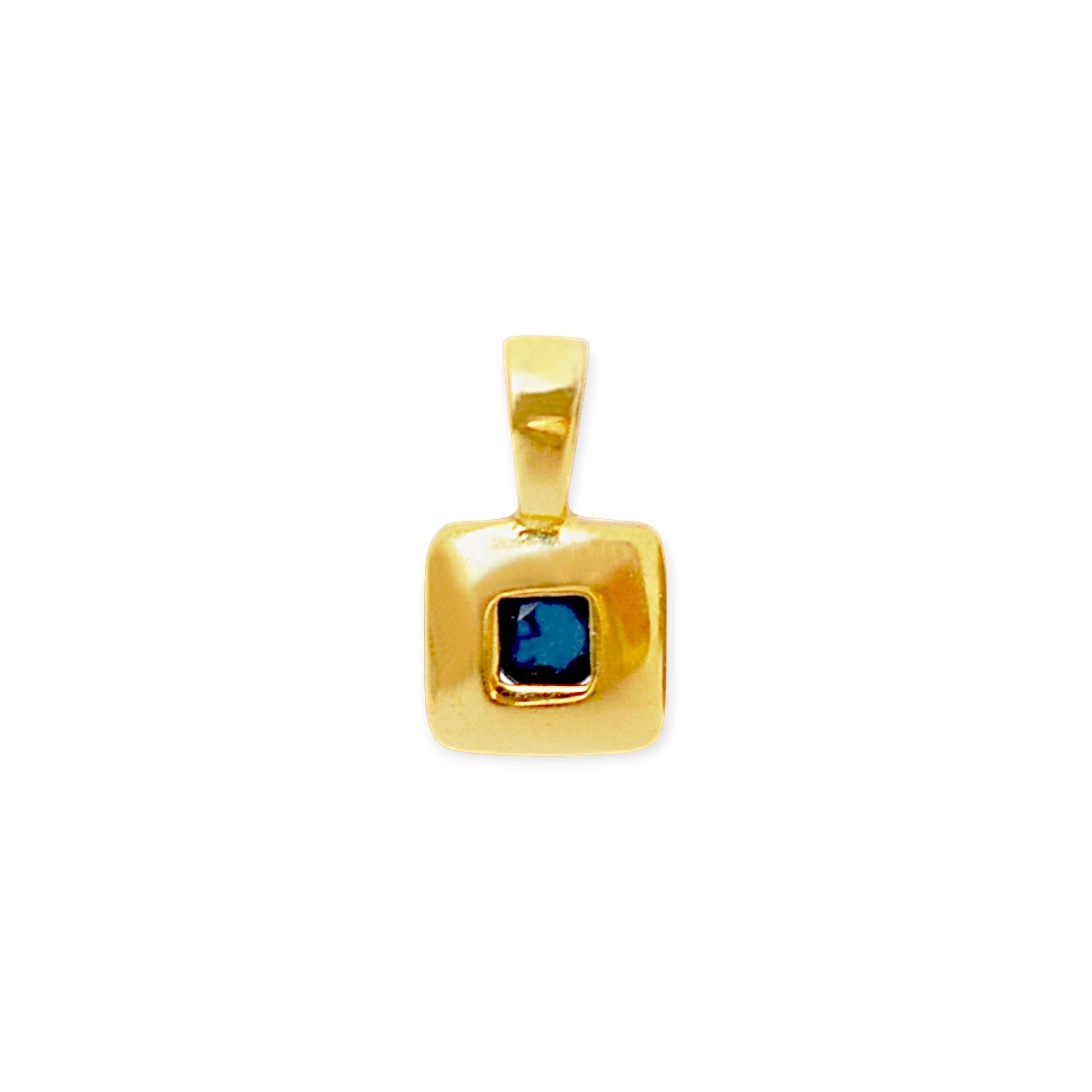 Elegant 18 Karat Yellow Gold vintage pendant featuring a polished, diamond-shaped design with a central bezel-set square sapphire.