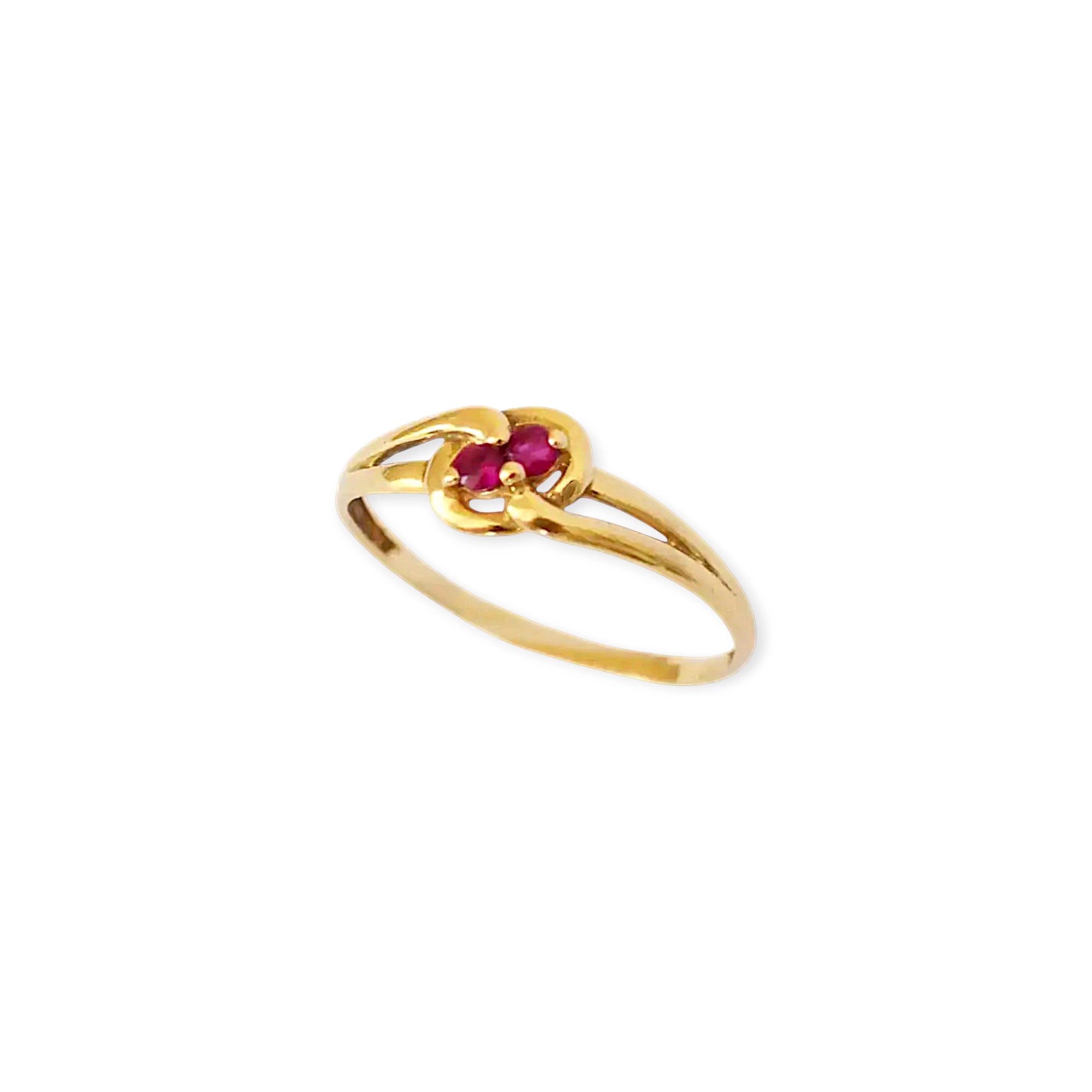 Elegant 18 Karat Yellow Gold vintage ring featuring two vibrant natural rubies nestled in a polished, swirling bypass setting.