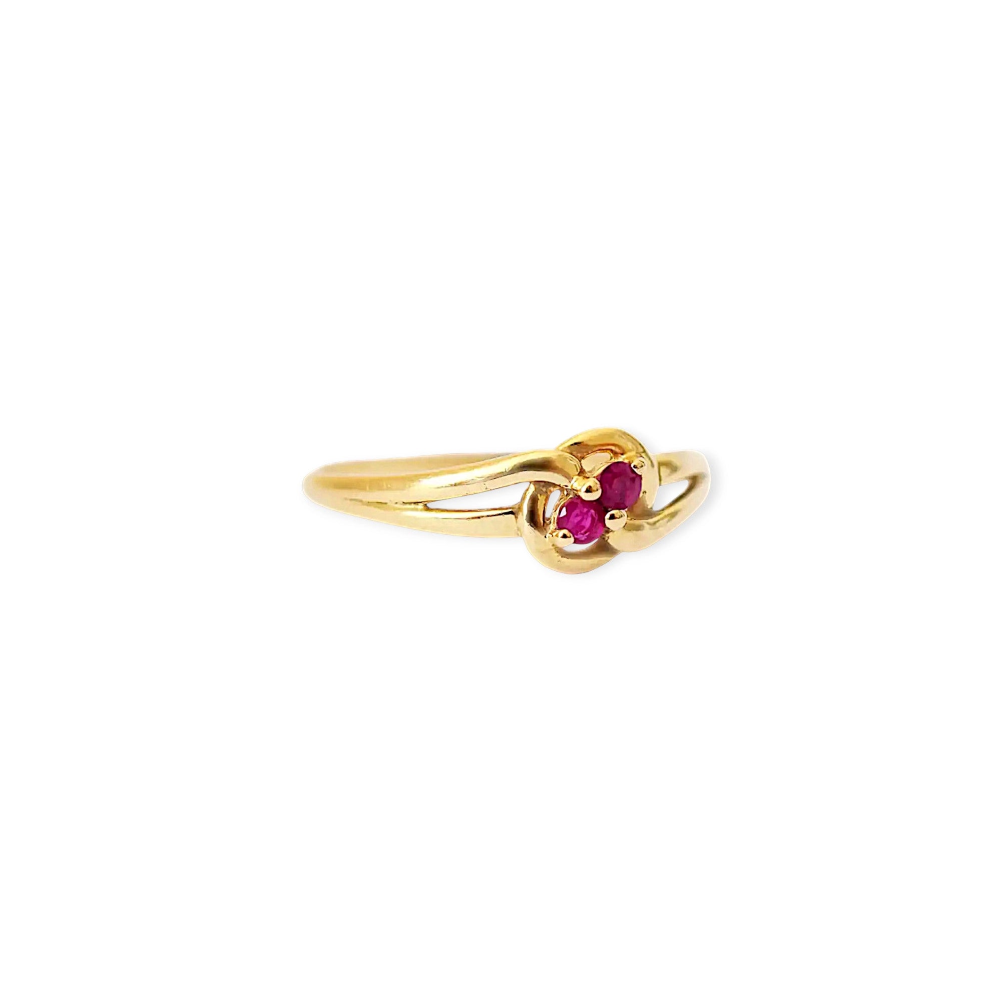 Elegant 18 Karat Yellow Gold vintage ring featuring two vibrant natural rubies nestled in a polished, swirling bypass setting.