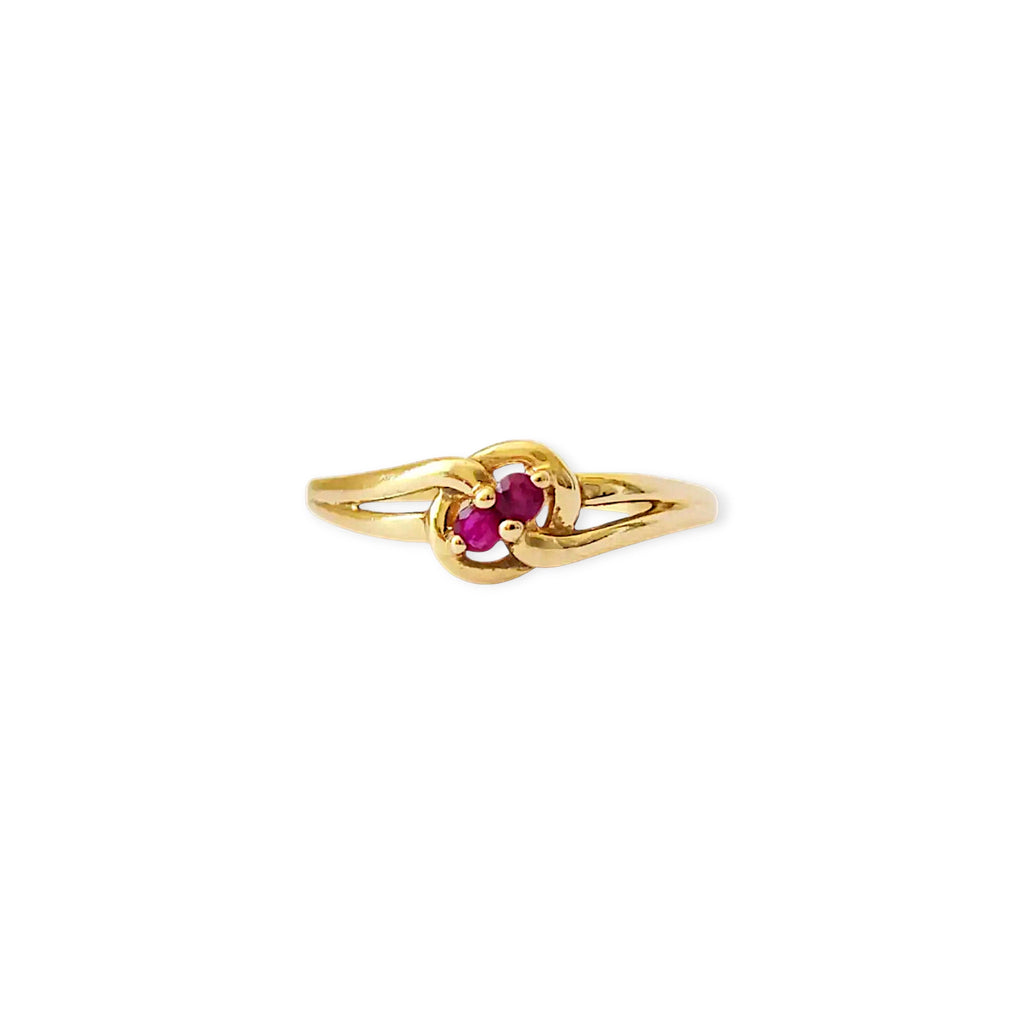 Elegant 18 Karat Yellow Gold vintage ring featuring two vibrant natural rubies nestled in a polished, swirling bypass setting.