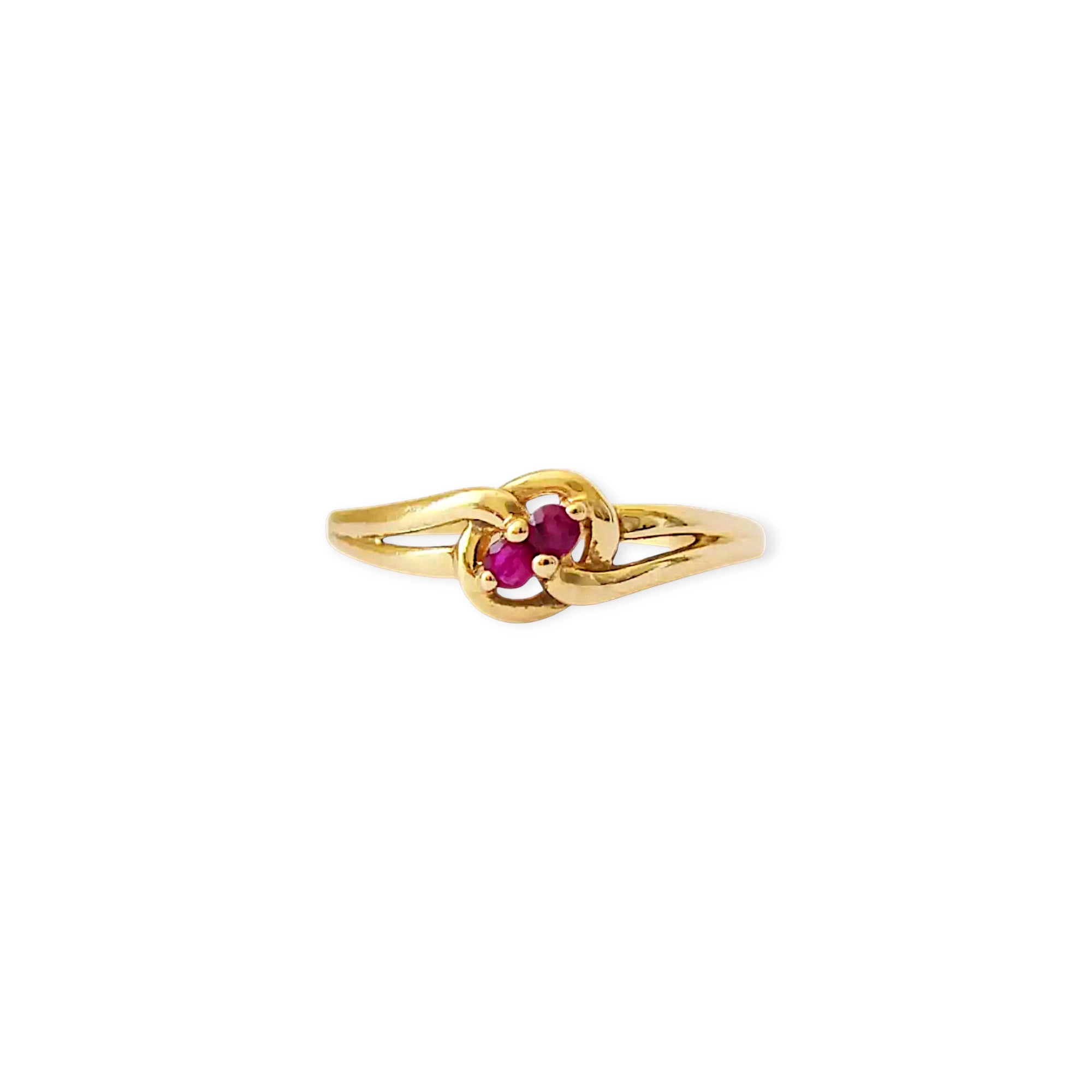 Elegant 18 Karat Yellow Gold vintage ring featuring two vibrant natural rubies nestled in a polished, swirling bypass setting.