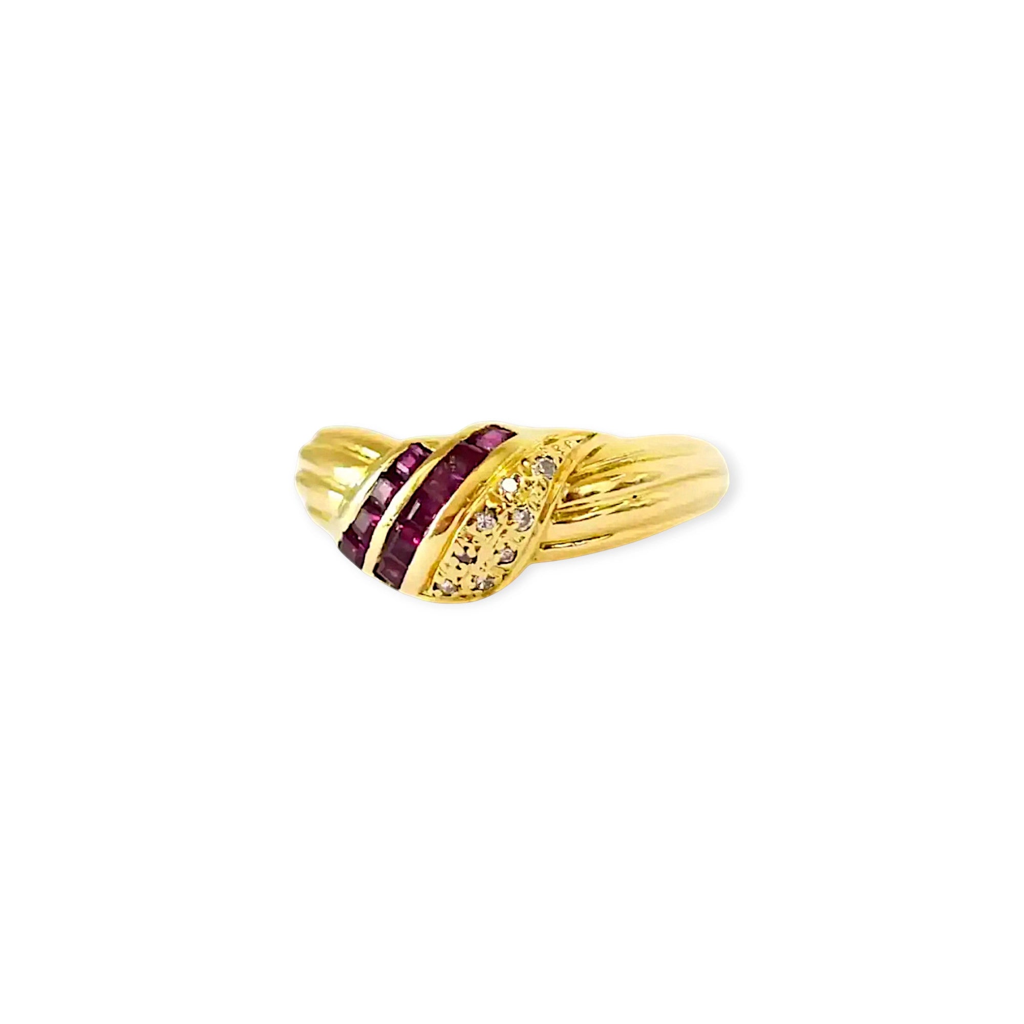 Elegant 18 Karat Yellow Gold Ring in a crossover design with channel-set baguette rubies and pavé-set diamonds.