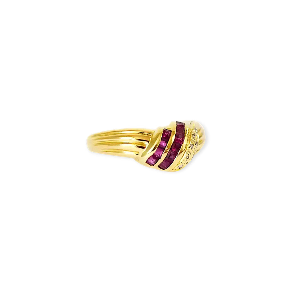 Elegant 18 Karat Yellow Gold Ring in a crossover design with channel-set baguette rubies and pavé-set diamonds.
