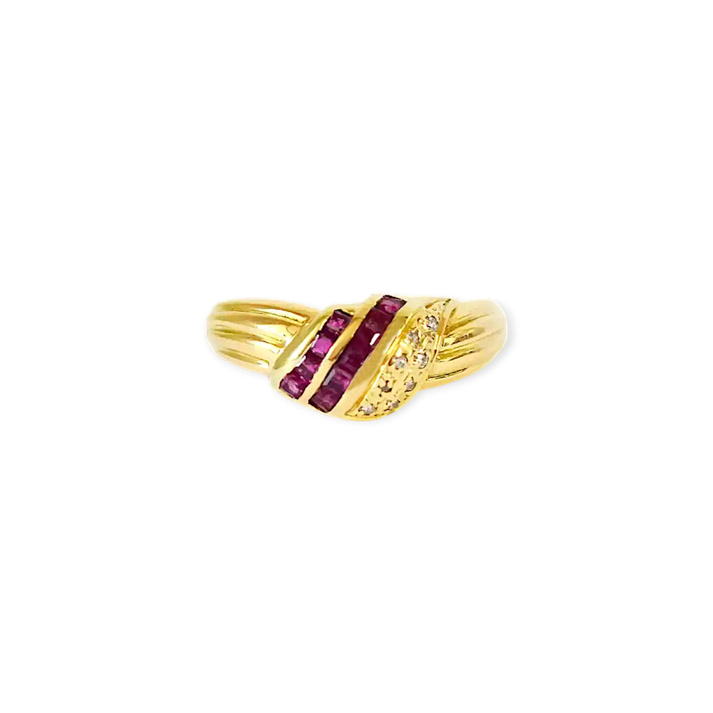 Elegant 18 Karat Yellow Gold Ring in a crossover design with channel-set baguette rubies and pavé-set diamonds.