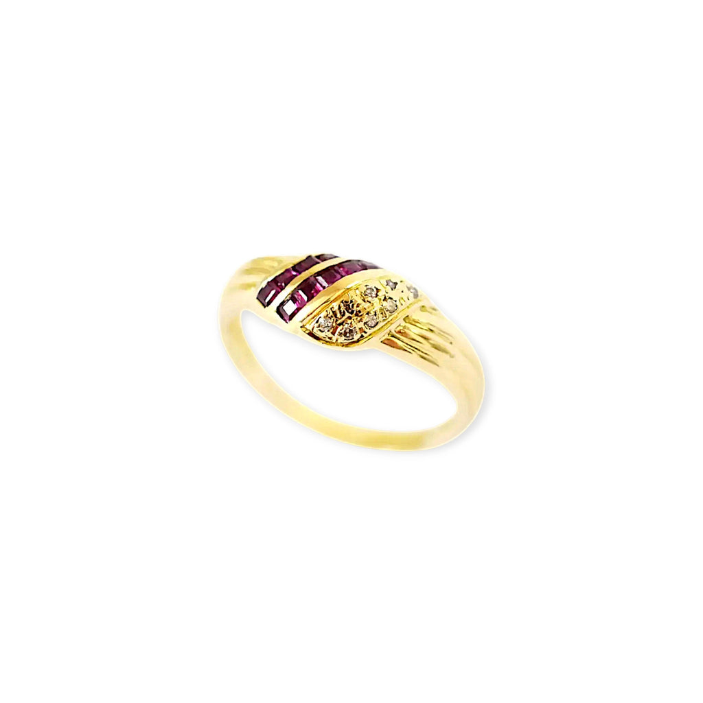Elegant 18 Karat Yellow Gold Ring in a crossover design with channel-set baguette rubies and pavé-set diamonds.
