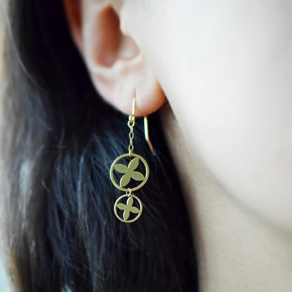 Modern 18K Yellow Gold drop earrings with a stacked double circle design and striking clover cut-out motif.
