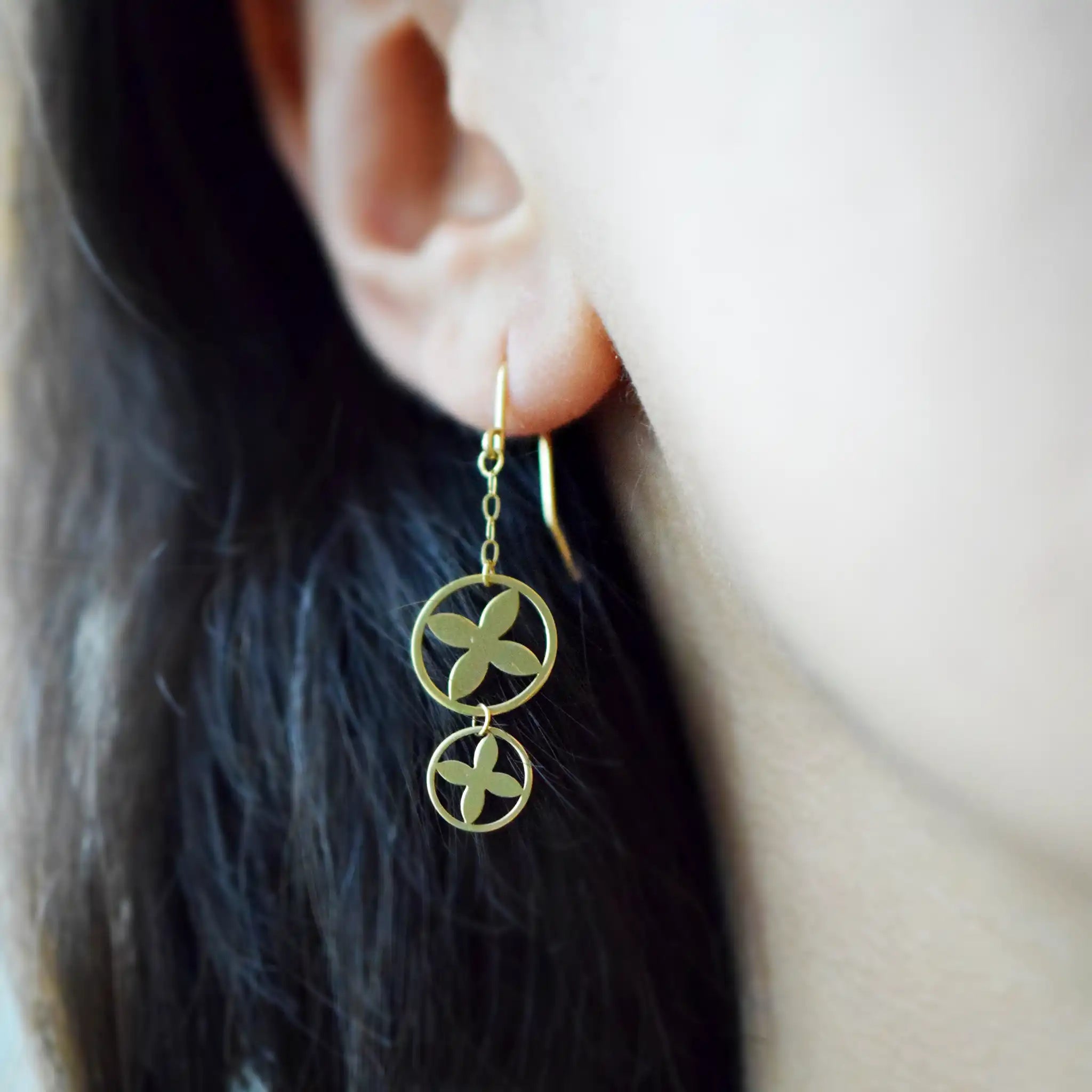 Modern 18K Yellow Gold drop earrings with a stacked double circle design and striking clover cut-out motif.