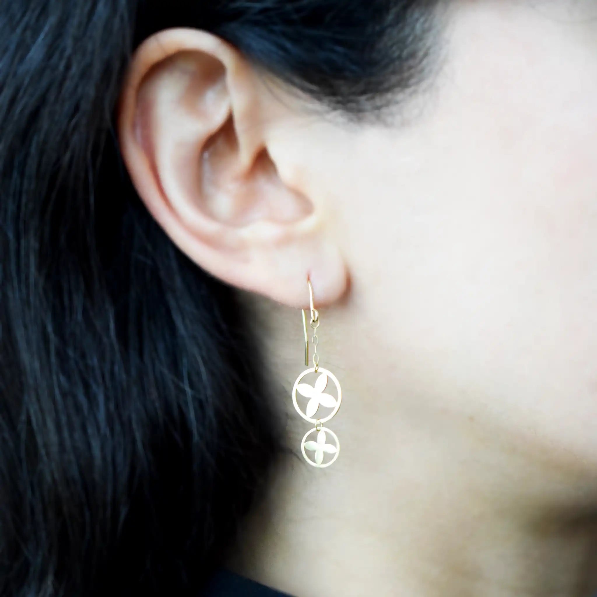 Modern 18K Yellow Gold drop earrings with a stacked double circle design and striking clover cut-out motif.