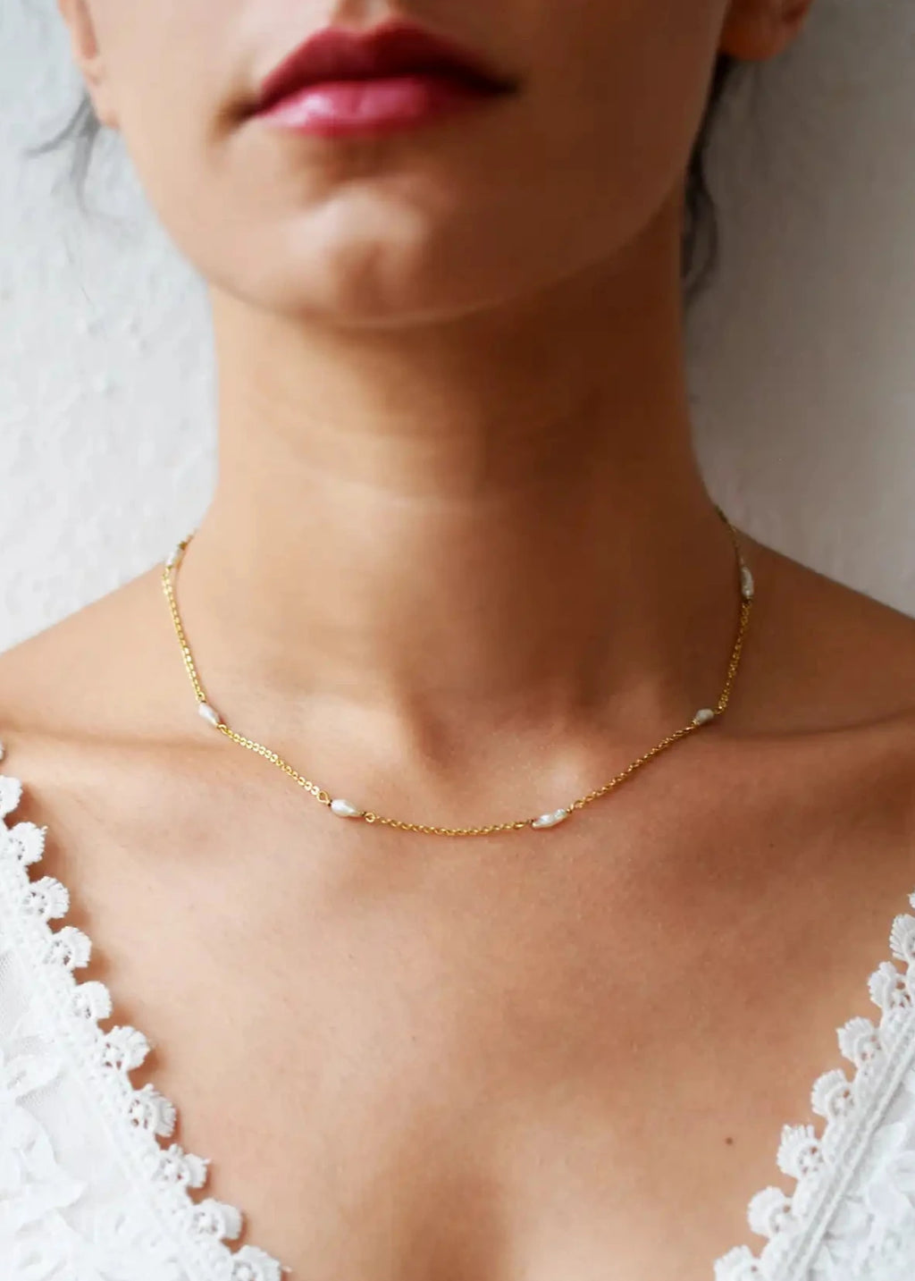 Romantic 18 Karat Yellow Gold necklace featuring irregularly shaped freshwater pearls stationed along a delicate link chain.