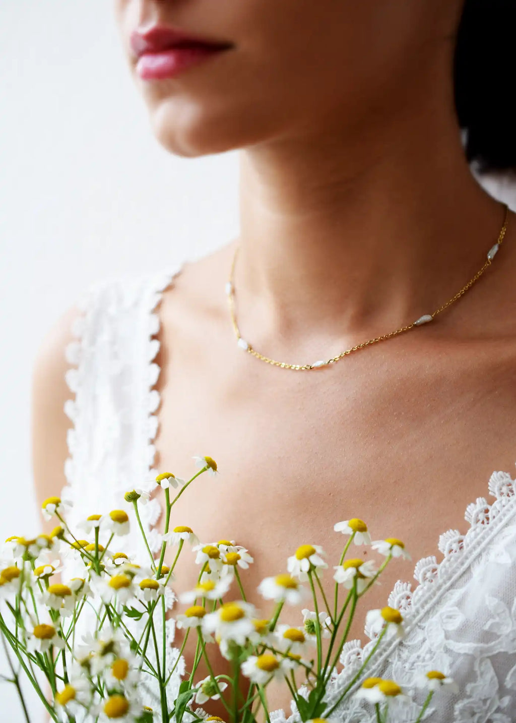 Romantic 18 Karat Yellow Gold necklace featuring irregularly shaped freshwater pearls stationed along a delicate link chain.